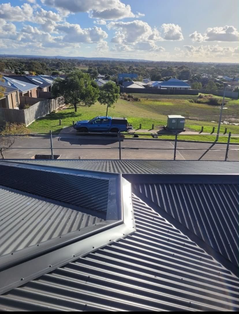 New charcoal Colorbond roof with flashed junction